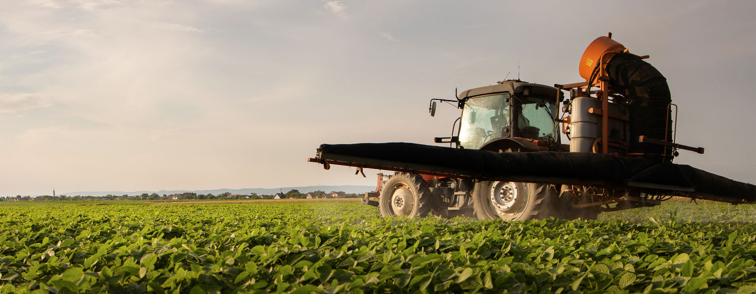 210226149_l@2x Tractor spraying soybean field