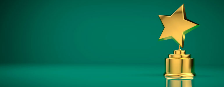 Gold star trophy on green background