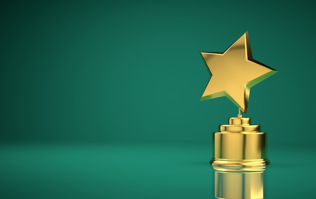 Gold star trophy on green background