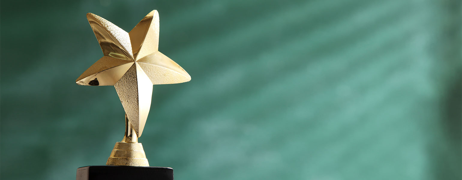 trophy in front of blackboard with light ray effect