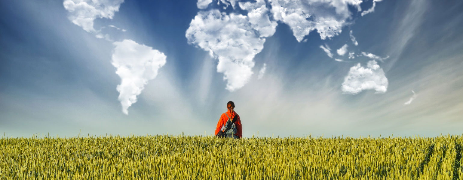 Clouds in the form of a map of the world over a hilly field