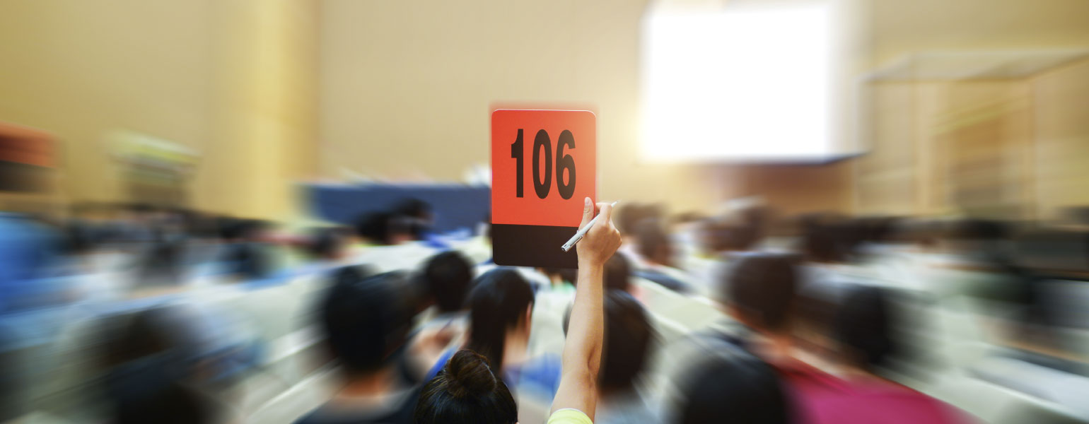 People holding up customer number pacing a bid